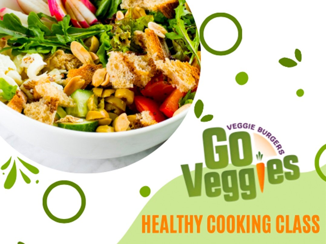 Colorful salad with fresh vegetables, nuts, and croutons in a white bowl, promoting a healthy cooking class by Go Veggies featuring veggie burgers.